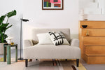 Load image into Gallery viewer, Beige sofa with decorative pillows in a living room setting with a wooden cabinet and plant.