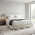 Load image into Gallery viewer, Beige bed in a modern bedroom with a lamp and window.