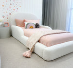 Load image into Gallery viewer, White bed with pink bedding and decorative pillows in a room with floral wallpaper and curtains.