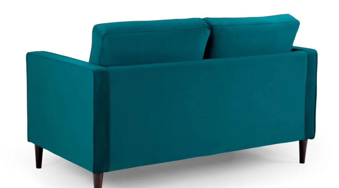 close up of Plush teal sofa in a white  background