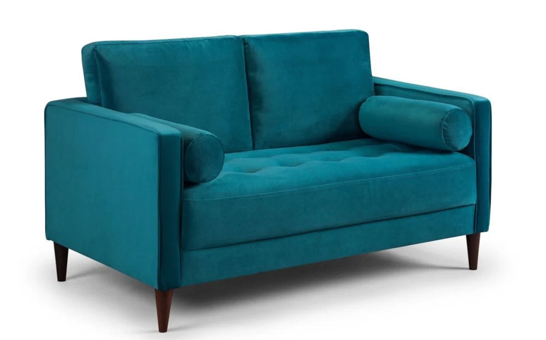 plush teal coloured sofa in a white background