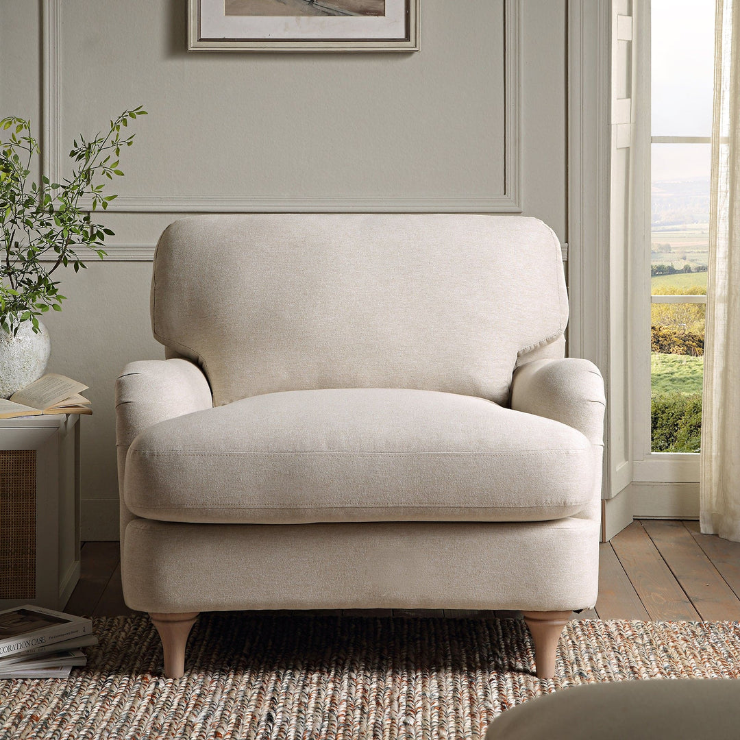 Beige armchair in a room with a window and plant
