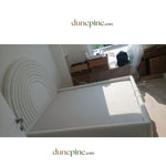 Load image into Gallery viewer, White folding table in a room with boxes and furniture, featuring dunepine.com branding.