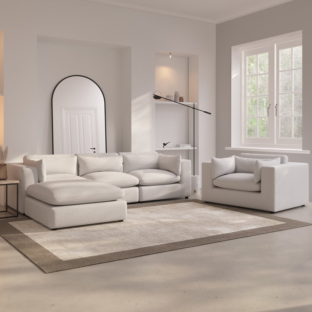 Modern living room with a white sofa set and a lamp.