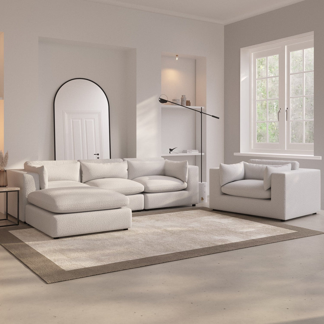 Modern living room with a white sofa set and a lamp.