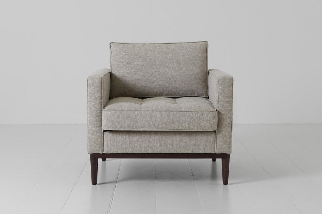 Gray armchair on a white floor with a white background