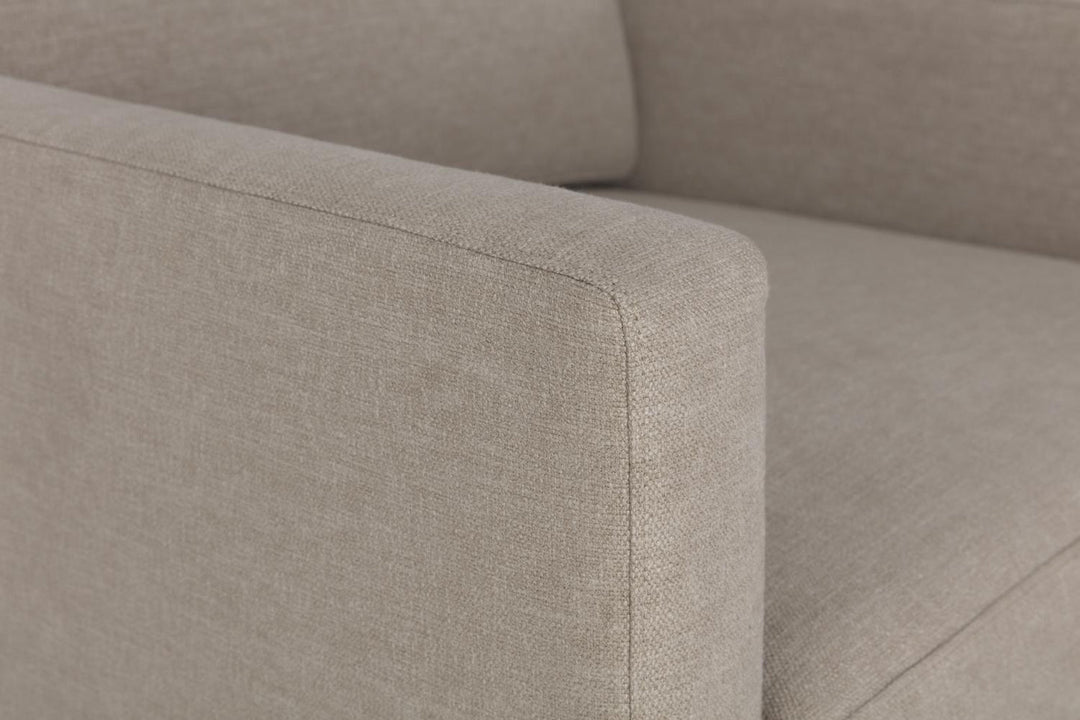 Close-up of a beige fabric sofa corner