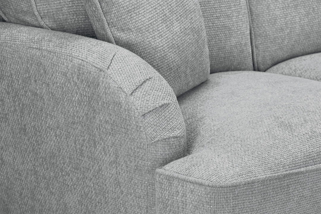 Gray fabric sofa with a focus on texture and stitching detail.