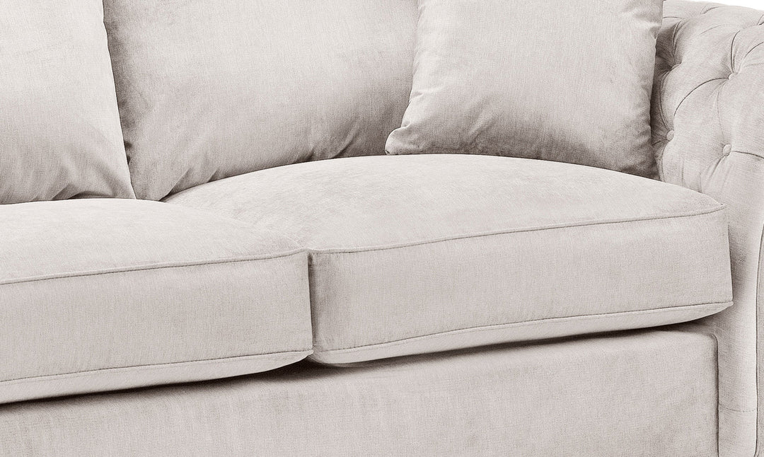 Close-up of a light gray sofa with cushions