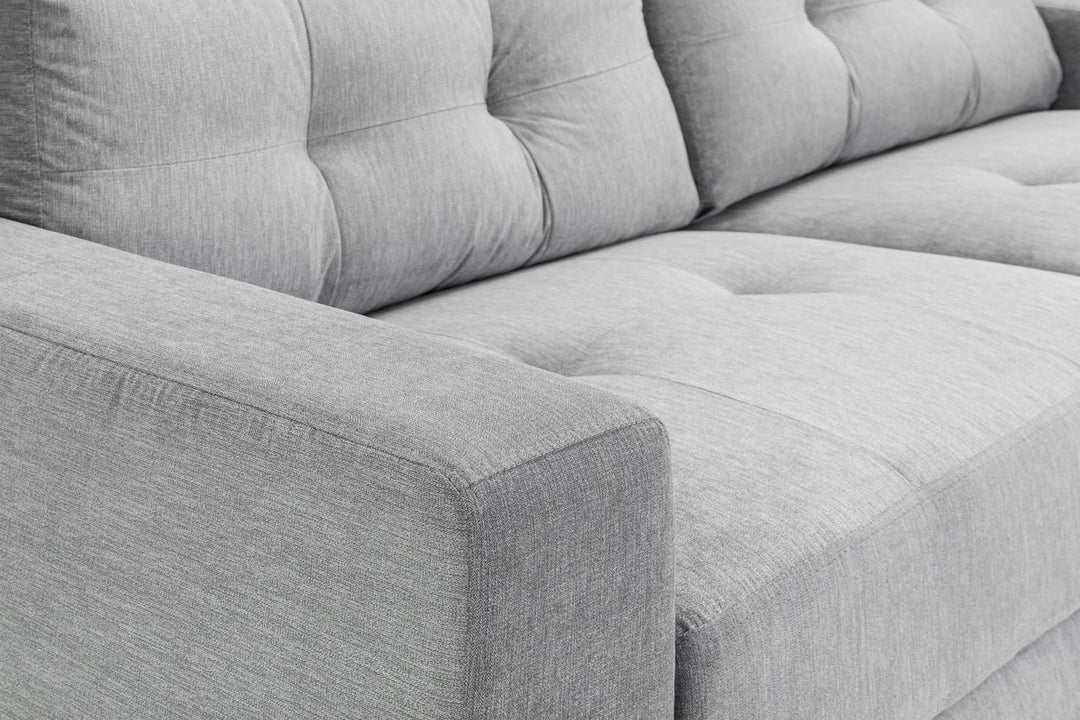 Gray sectional sofa with tufted backrests