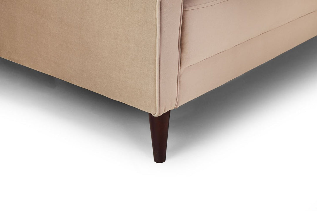 Close-up of a beige upholstered chair with a wooden leg on a white background