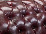Load image into Gallery viewer, Close-up of a brown leather sofa with tufted design