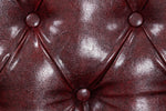 Load image into Gallery viewer, Close-up of a brown leather cushion with button details