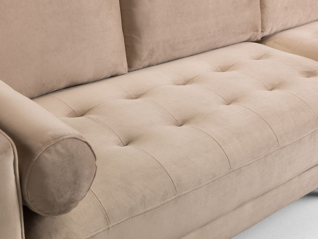 Beige sofa with tufted backrest and armrests on a light background