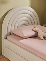 Load image into Gallery viewer, Children's bed with pink mattress, pillow, and unicorn toy against a beige wall.