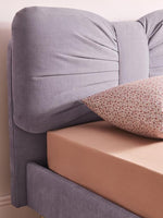 Load image into Gallery viewer, Gray upholstered headboard with a brown mattress and patterned pillow.