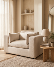 Beige bouclé love seat armchair in a reading corner – Dune & Pine