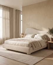 Curved upholstered divan bed in a warm bedroom – Dune & Pine