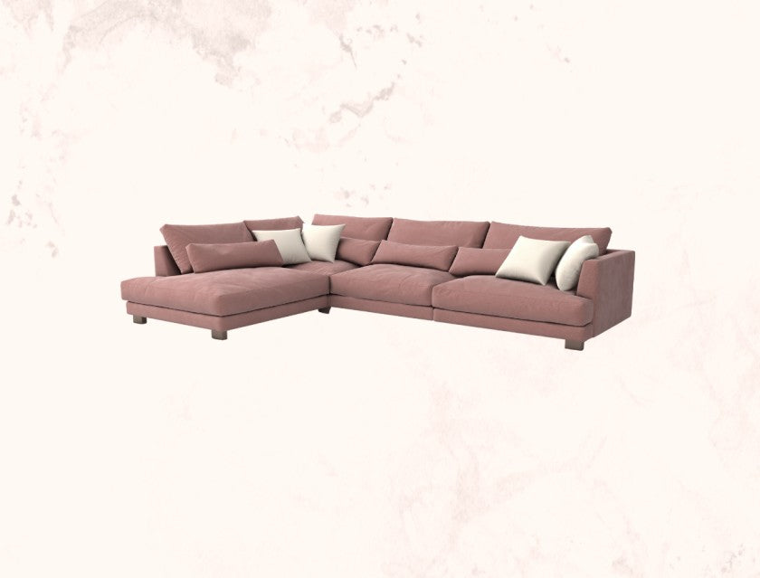 Pink sectional sofa with white cushions on a light pink background