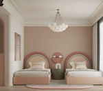 Load image into Gallery viewer, Modern bedroom with two pink beds, a round mirror, and a chandelier.