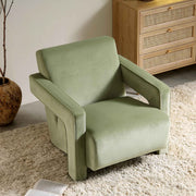 Green armchair in a room with a wooden cabinet and a plant.