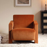 Brown armchair in a room with a side table and framed picture on the wall.