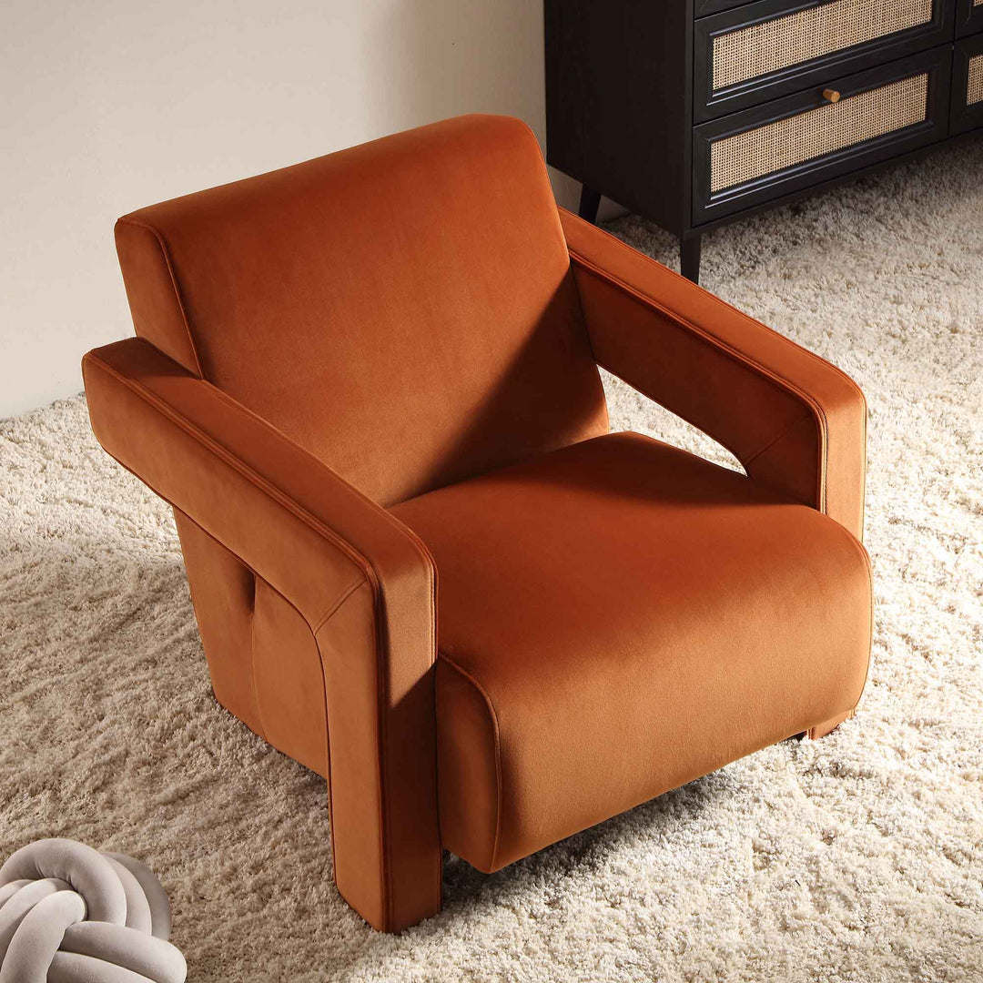 Brown armchair on a carpeted floor with a neutral wall and cabinet in the background