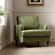 Green armchair in a room with a neutral color scheme