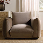 Load image into Gallery viewer, Beige armchair with a pillow in a room with curtains and a vase.
