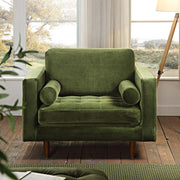 Green armchair in a room with large windows and wooden flooring