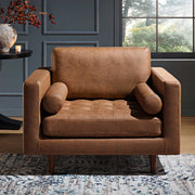 Brown leather armchair in a room with a window and decorative elements.