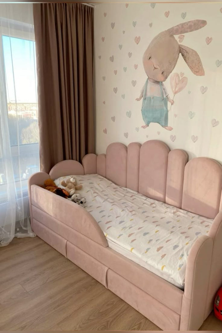 Children's room with a pink bed, teddy bears, and a wall with a bunny illustration.