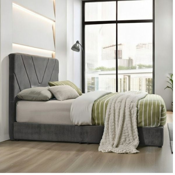 Modern bedroom with a gray upholstered bed and striped bedding.