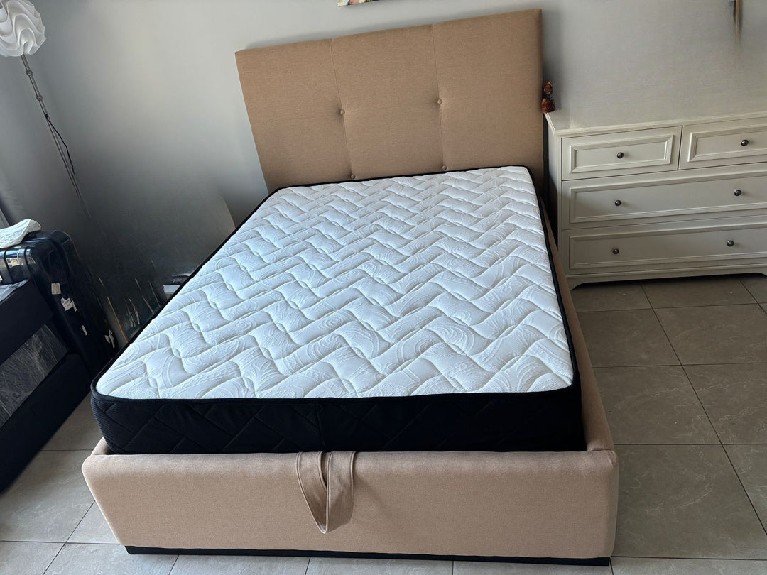 Beige bed frame with mattress in a room setting