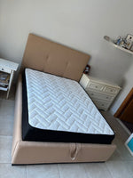 Load image into Gallery viewer, Beige bed frame with a mattress in a room setting.
