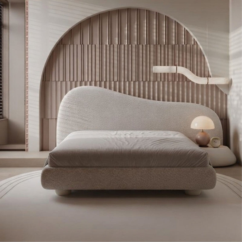 Modern bed with a textured headboard in a minimalistic room.