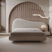 Modern bed with a textured headboard in a minimalistic room.