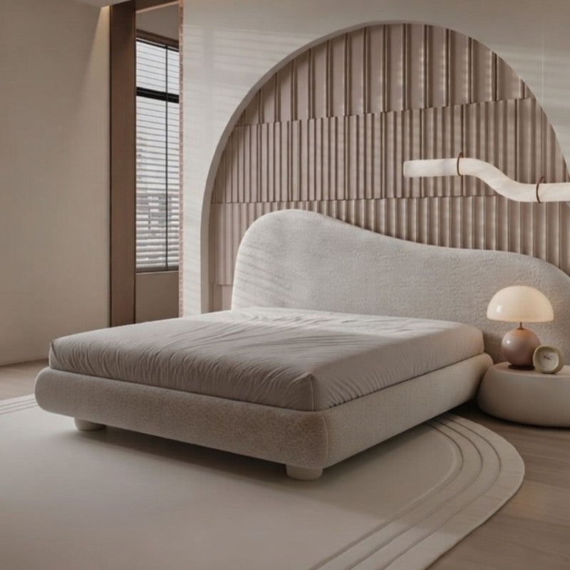 Modern bedroom with a beige bed and decorative wall.