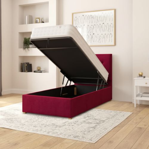Red upholstered storage bed with open lid in a room setting.