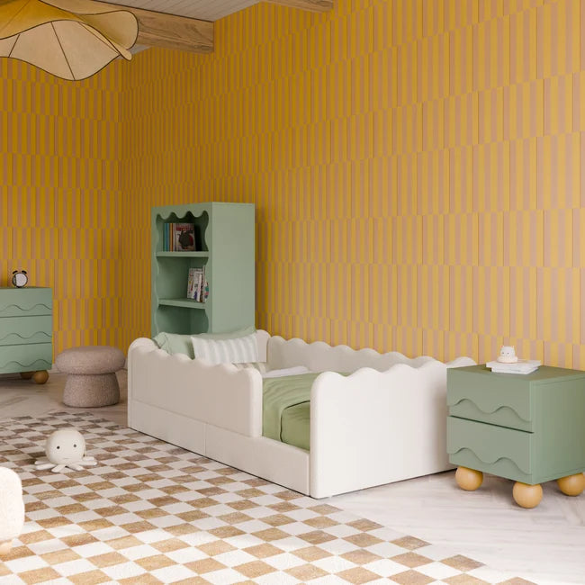 Children's room with yellow patterned walls, green furniture, and a white bed.