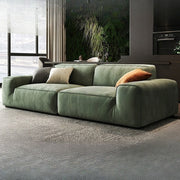 Green sofa in a living room with a modern decor.