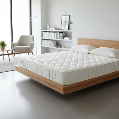 White mattress on a wooden bed frame in a modern bedroom.