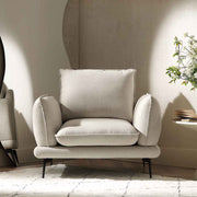 Beige armchair in a room with a neutral color scheme