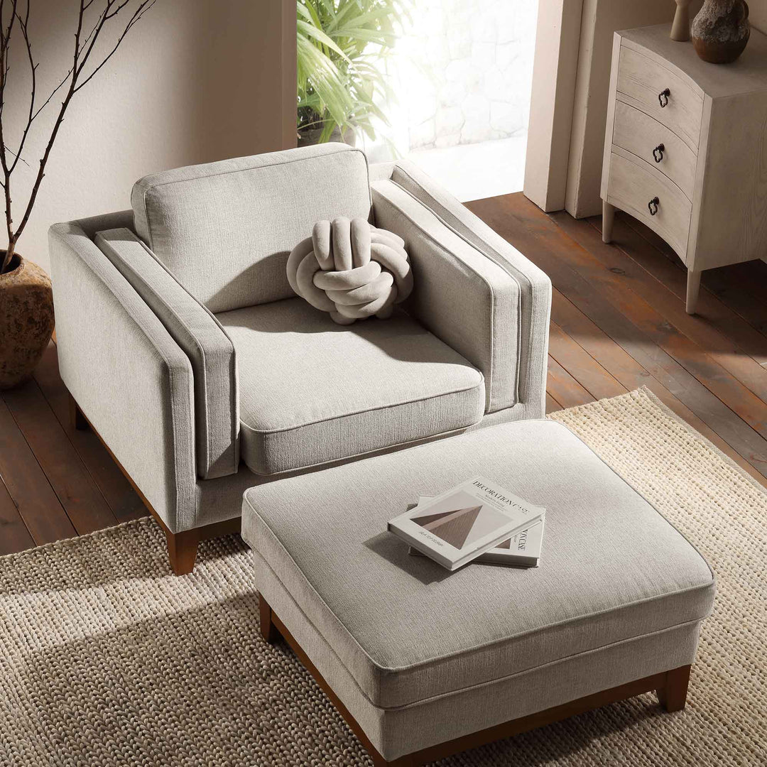 Gray armchair with matching ottoman in a living room setting