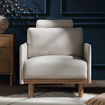 Load image into Gallery viewer, Beige armchair in a room with dark blue walls and wooden furniture.
