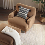 Load image into Gallery viewer, Beige armchair with a patterned pillow in a cozy living room setting.
