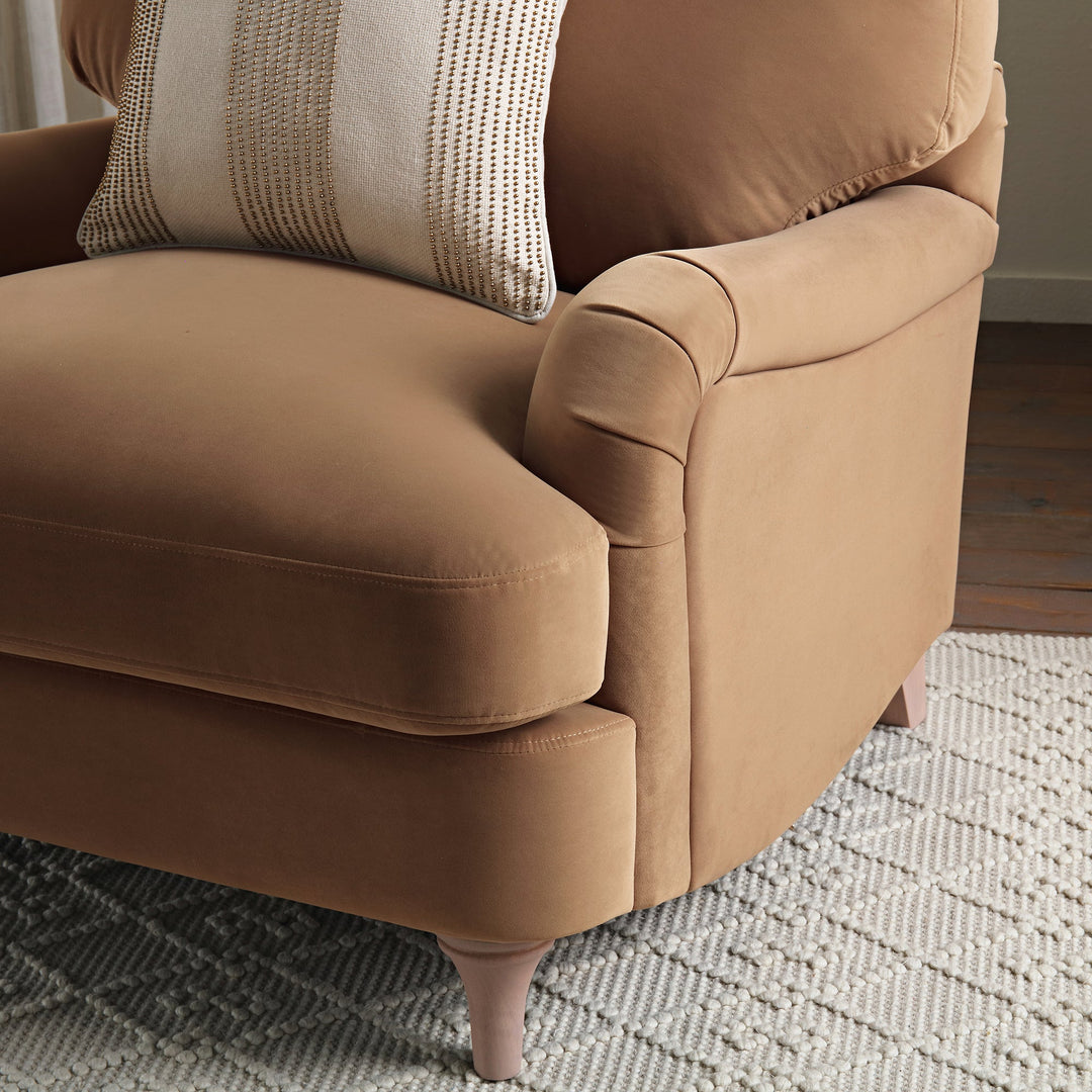 Brown armchair with a textured pillow on a patterned rug