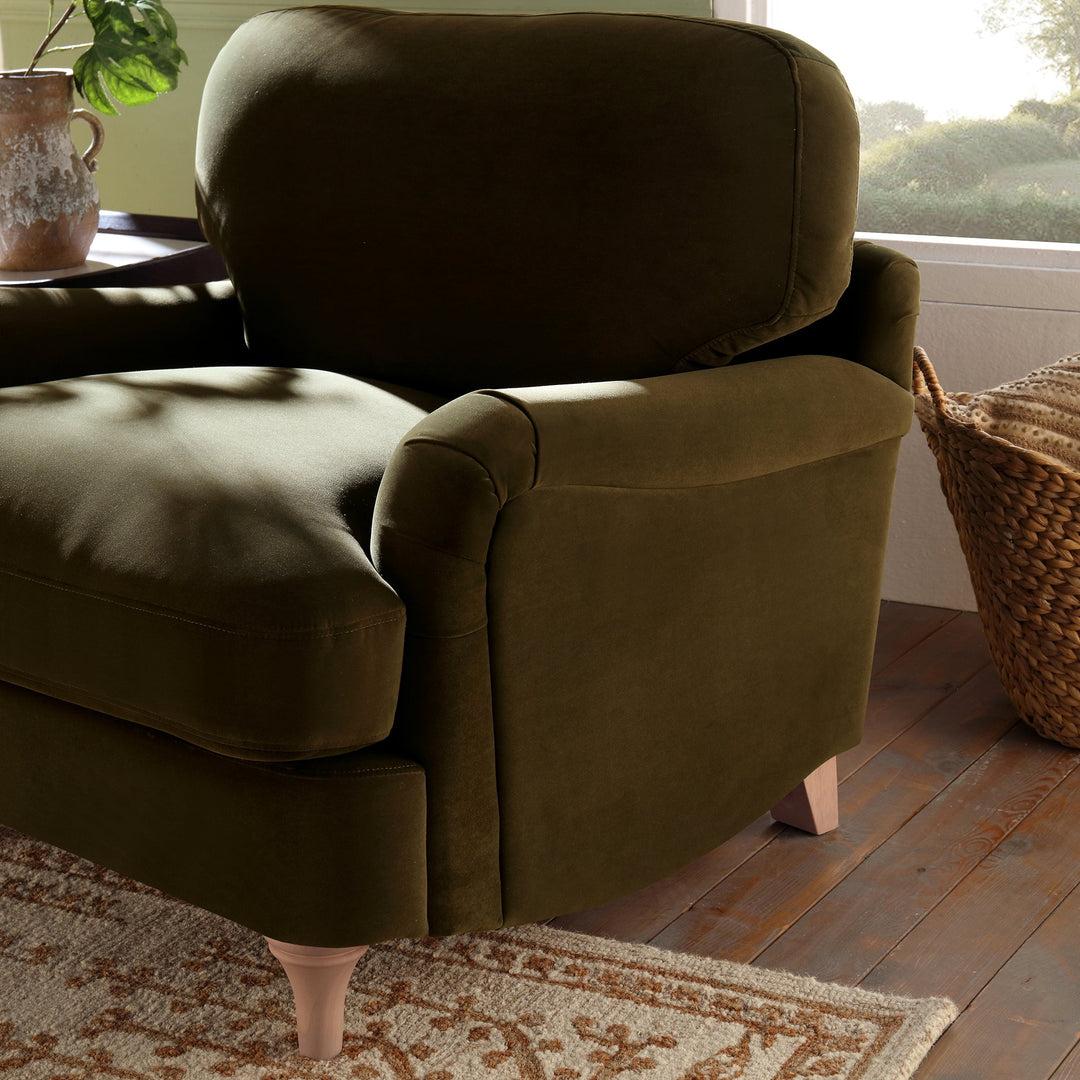 Brown armchair in a room with a window and rug