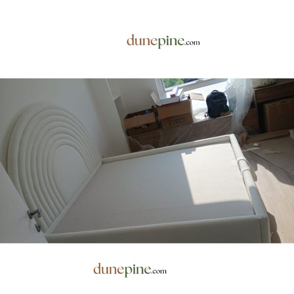 White folding table in a room with boxes and furniture, featuring dunepine.com branding.