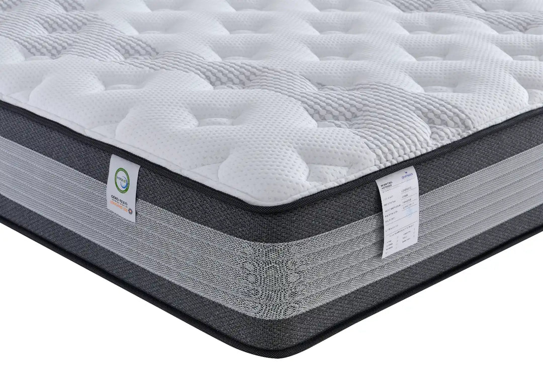 Gray and white mattress with a brand label on a white background
